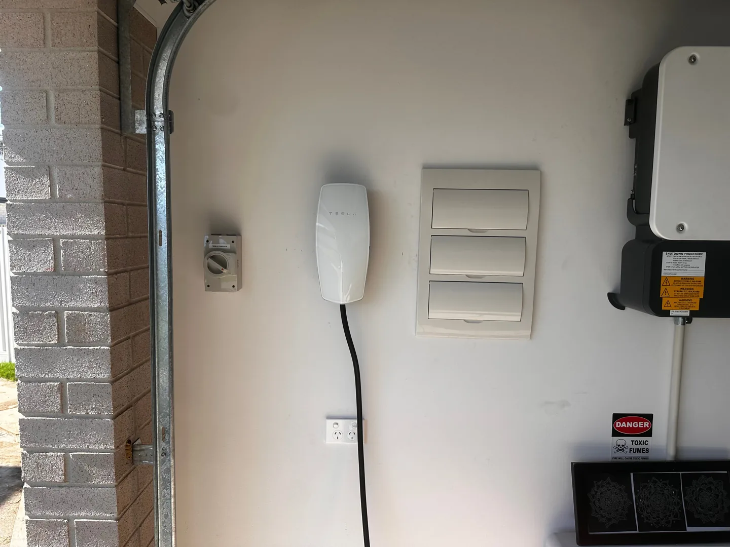 Tesla EV charger installation with solar equipment